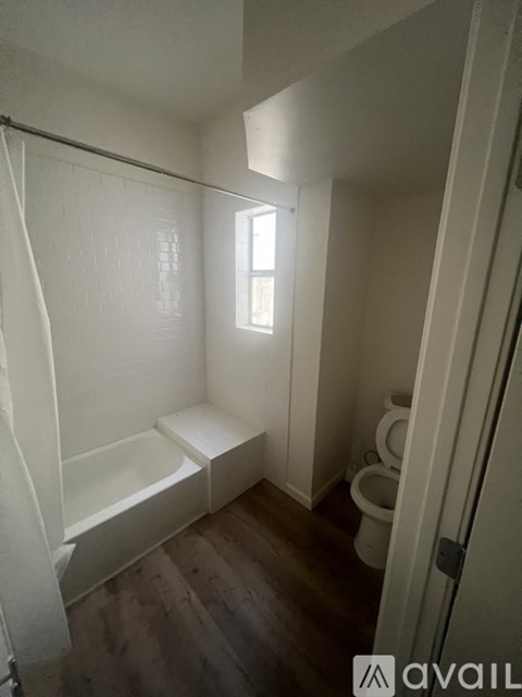 A bathroom with a toilet, sink, and bathtub.