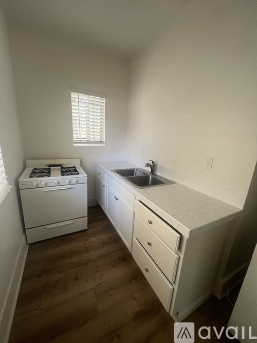 A small kitchen with a white oven and sink.