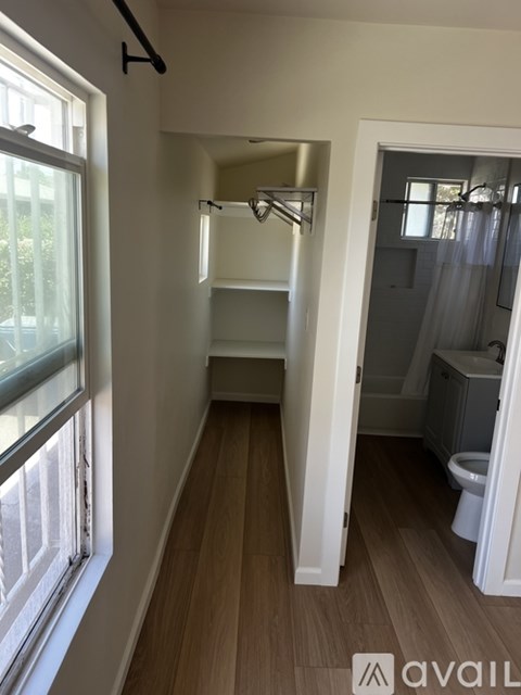 A bathroom with a toilet, sink, and mirror.