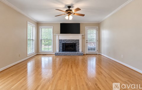 A living room with a fireplace and a flat screen TV.