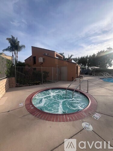 A hot tub sits in the middle of a patio.