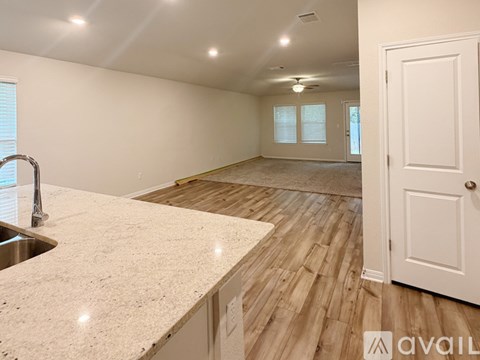 A spacious room with a sink and a door.