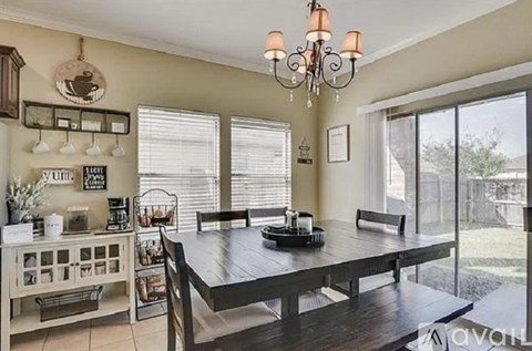 A dining room with a wooden table and chairs.