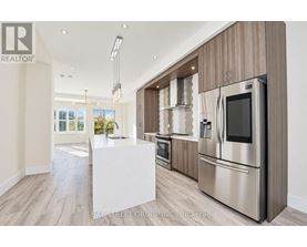 A modern kitchen with stainless steel appliances and wooden cabinets.