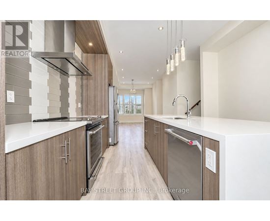 A modern kitchen with wooden cabinets and stainless steel appliances.