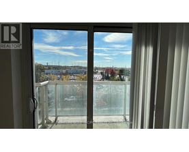 A view from a window with a glass door and a white frame.