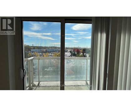 A view from a window with a glass door and a white frame.