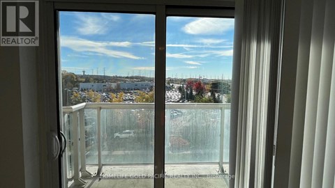 A view from a window with a glass door and a white frame.