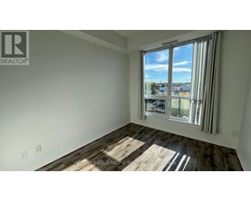 A room with a large window overlooking a cityscape.