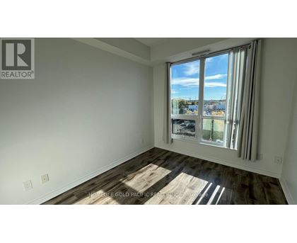 A room with a large window overlooking a cityscape.