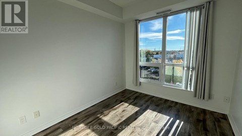 A room with a large window overlooking a cityscape.