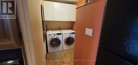 A small laundry room with a washer and dryer.
