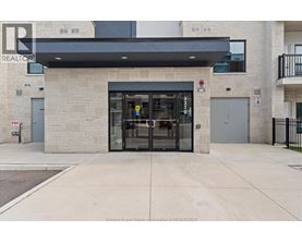 The entrance to a building with a glass door and a sign above it.