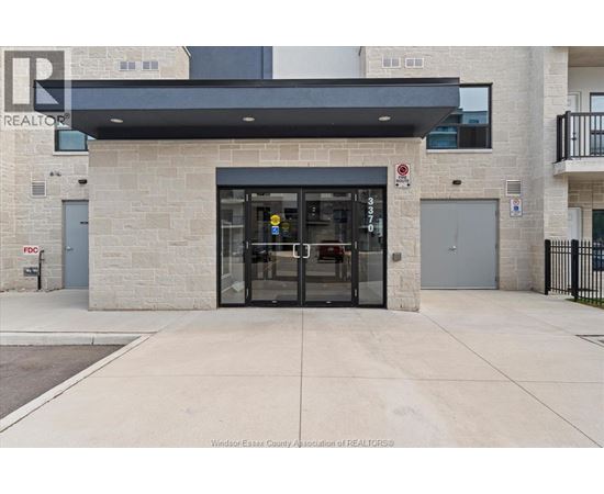 The entrance to a building with a glass door and a sign above it.