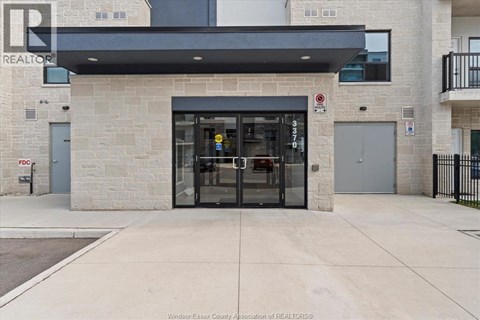 The entrance to a building with a glass door and a sign above it.
