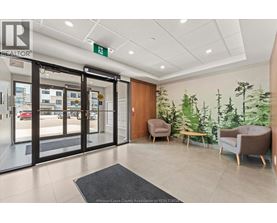 A realtor office with a glass door and a green sign on the wall.