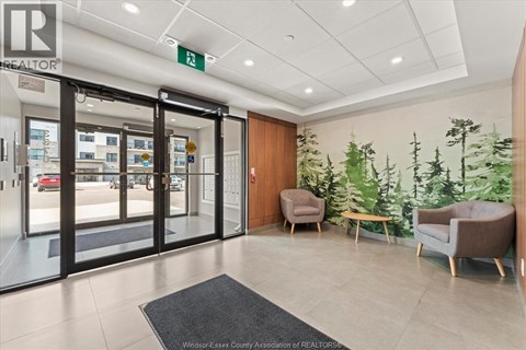 A realtor office with a glass door and a green sign on the wall.