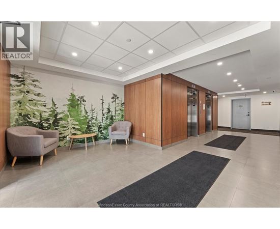 A well-lit office lobby with a green plant wall and a wooden reception desk.