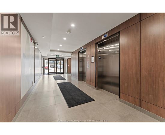 A hallway with a REALTOR® logo on the wall.