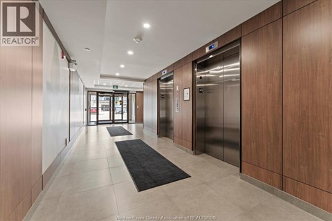 A hallway with a REALTOR® logo on the wall.