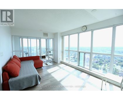 A bedroom with a large bed and a view of the city.