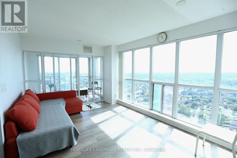 A bedroom with a large bed and a view of the city.