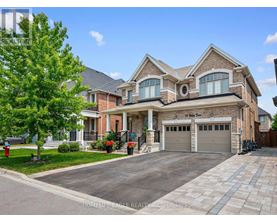 A large, well-maintained house with a driveway and garage.