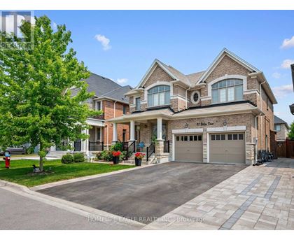 A large, well-maintained house with a driveway and garage.