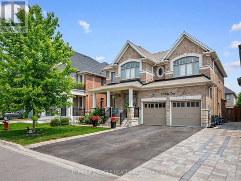 A large, well-maintained house with a driveway and garage.