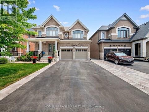 A large, well-maintained house with a driveway in front.