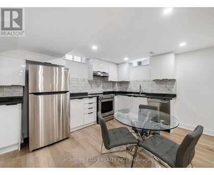 A modern kitchen with a glass table and chairs.