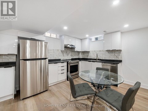 A modern kitchen with a glass table and chairs.