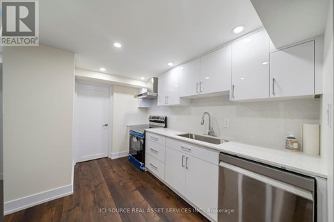 A kitchen with white cabinets and a stainless steel dishwasher.