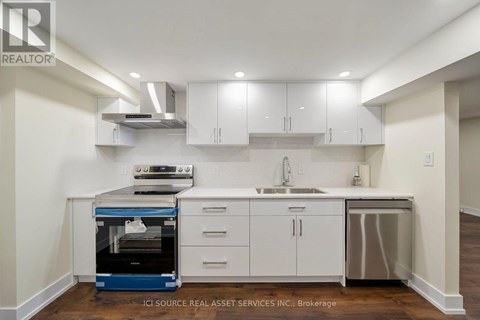 A kitchen with white cabinets and a blue oven.