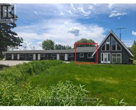 A house with a red square drawn on it is surrounded by greenery.