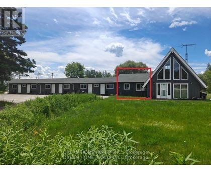 A house with a red square drawn on it is surrounded by greenery.