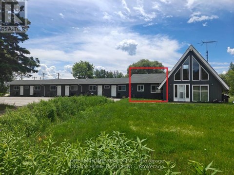 A house with a red square drawn on it is surrounded by greenery.