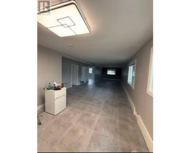 A room with a white cabinet and a tiled floor.