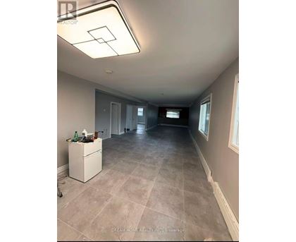 A room with a white cabinet and a tiled floor.