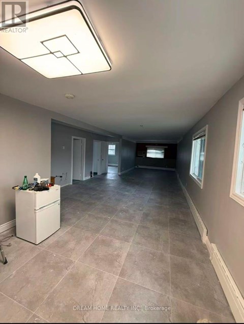 A room with a white cabinet and a tiled floor.