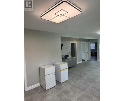A kitchen area with a white fridge and a white dishwasher.