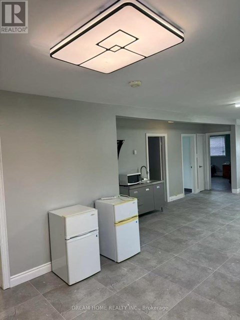 A kitchen area with a white fridge and a white dishwasher.