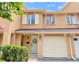 A house with a white garage door and a wreath on the door.