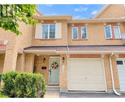 A house with a white garage door and a wreath on the door.