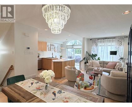 A well-lit, modern living room with a dining table set for two.