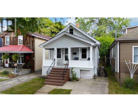A house with a red awning and a white porch.