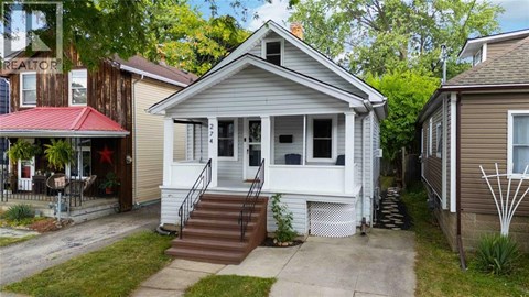 A house with a red awning and a white porch.