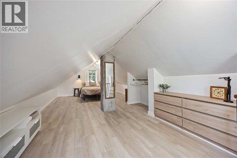 A bedroom with a bed and a dresser is shown in this image.