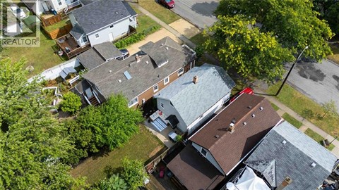 A bird's eye view of a residential area with houses and trees.