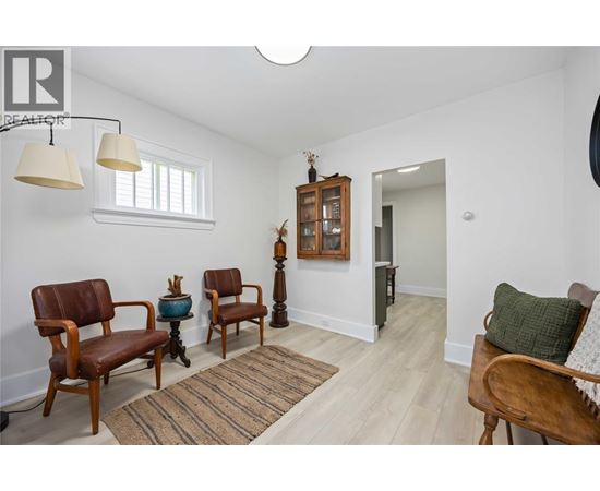 A living room with a brown chair and a wooden cabinet.